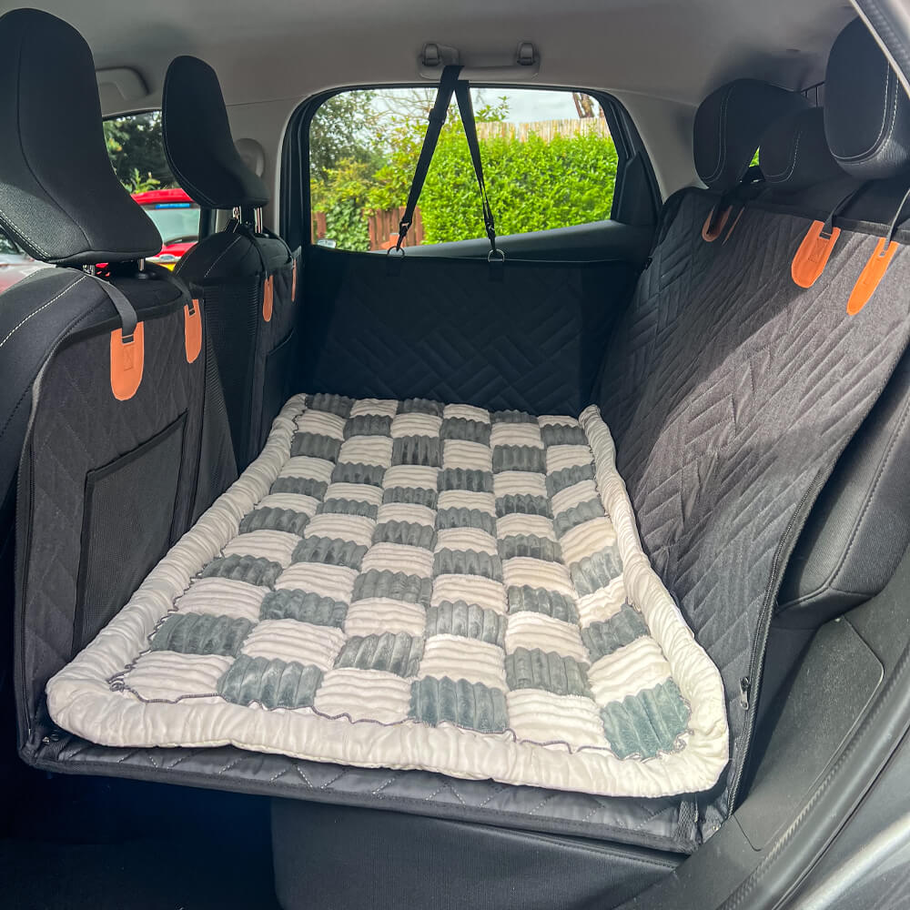 Gray plaid dog car bed mat covering rear cargo area