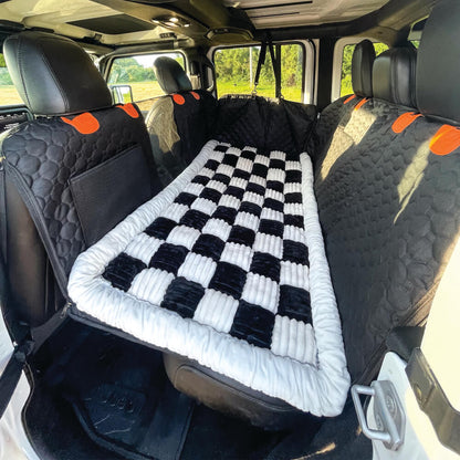 Black and white plaid dog car bed mat in truck back seat
