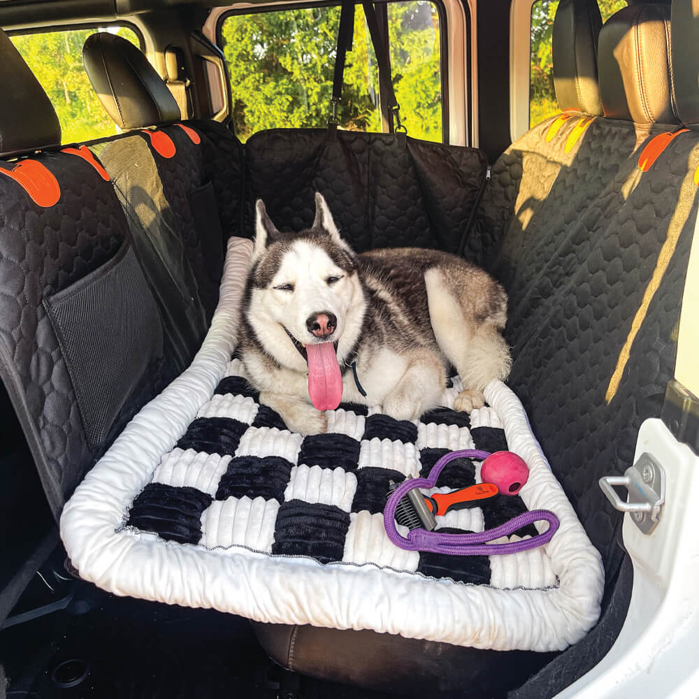 Dog resting on black plaid anti-slip car bed mat